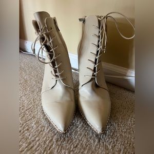 Cream heeled boots with lace up detail and silver studs